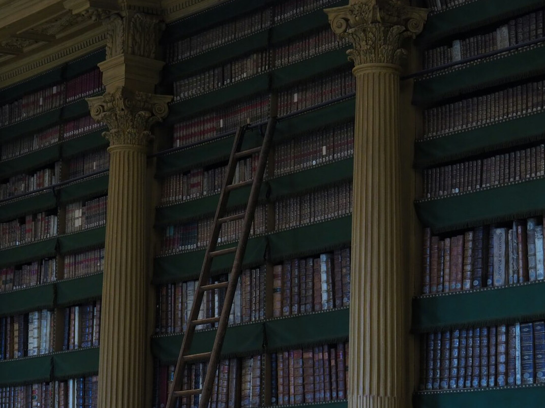 Old library with tall shelves full of books