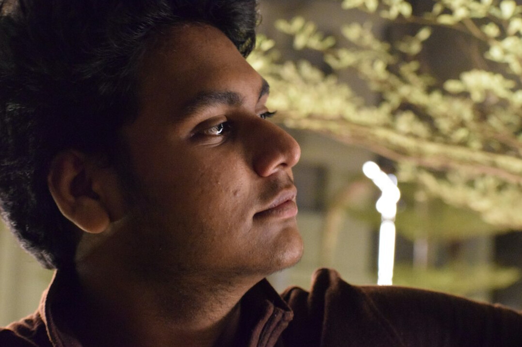Portrait of a young man in a shirt looking to the side