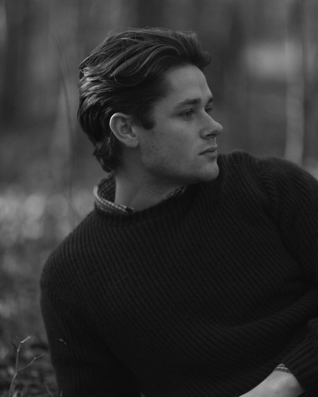 Portrait of a smiling man in his thirties in a dark sweater